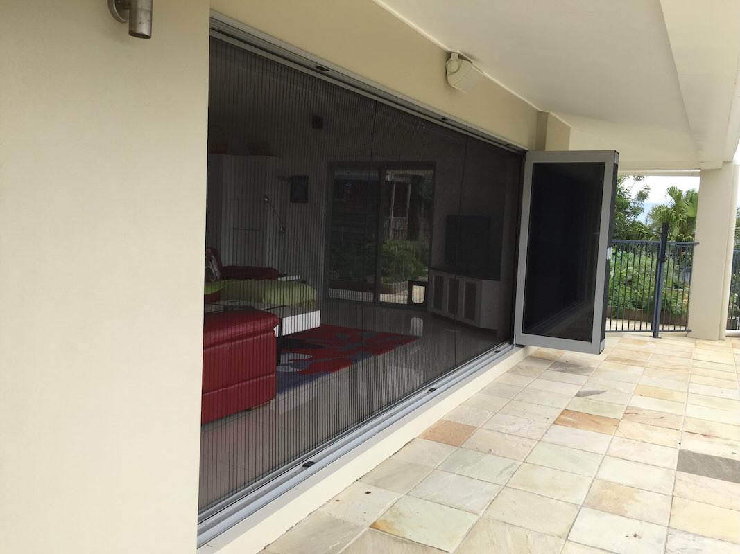 retractable fly screens for bifold doors in a modern Brisbane home looking in from the outdoors