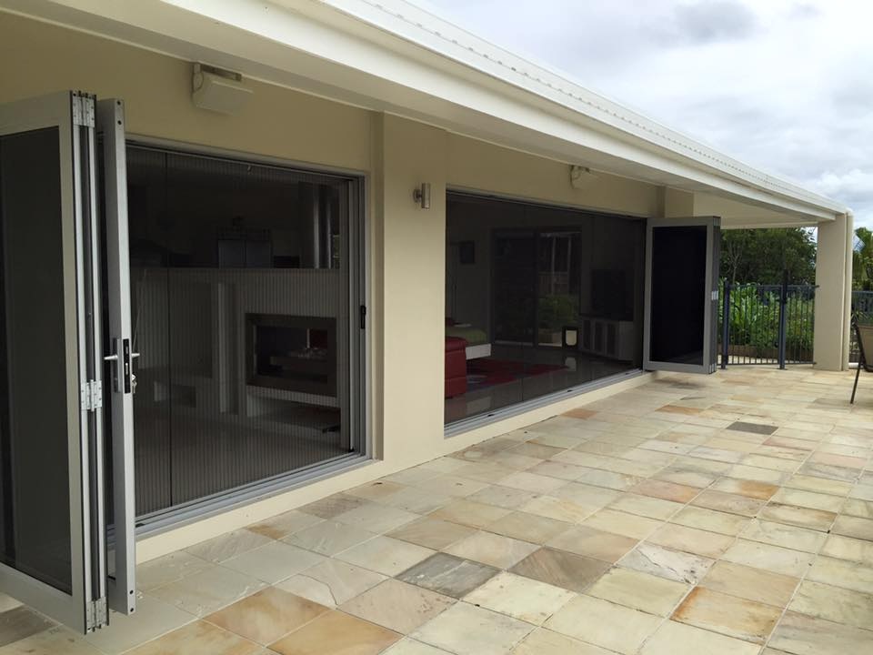 Retractable insect screens on a Brisbane home showing double doors opening onto a patio