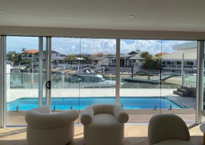 Double sliding retractable fly screens overlooking pool in Mermaid Waters