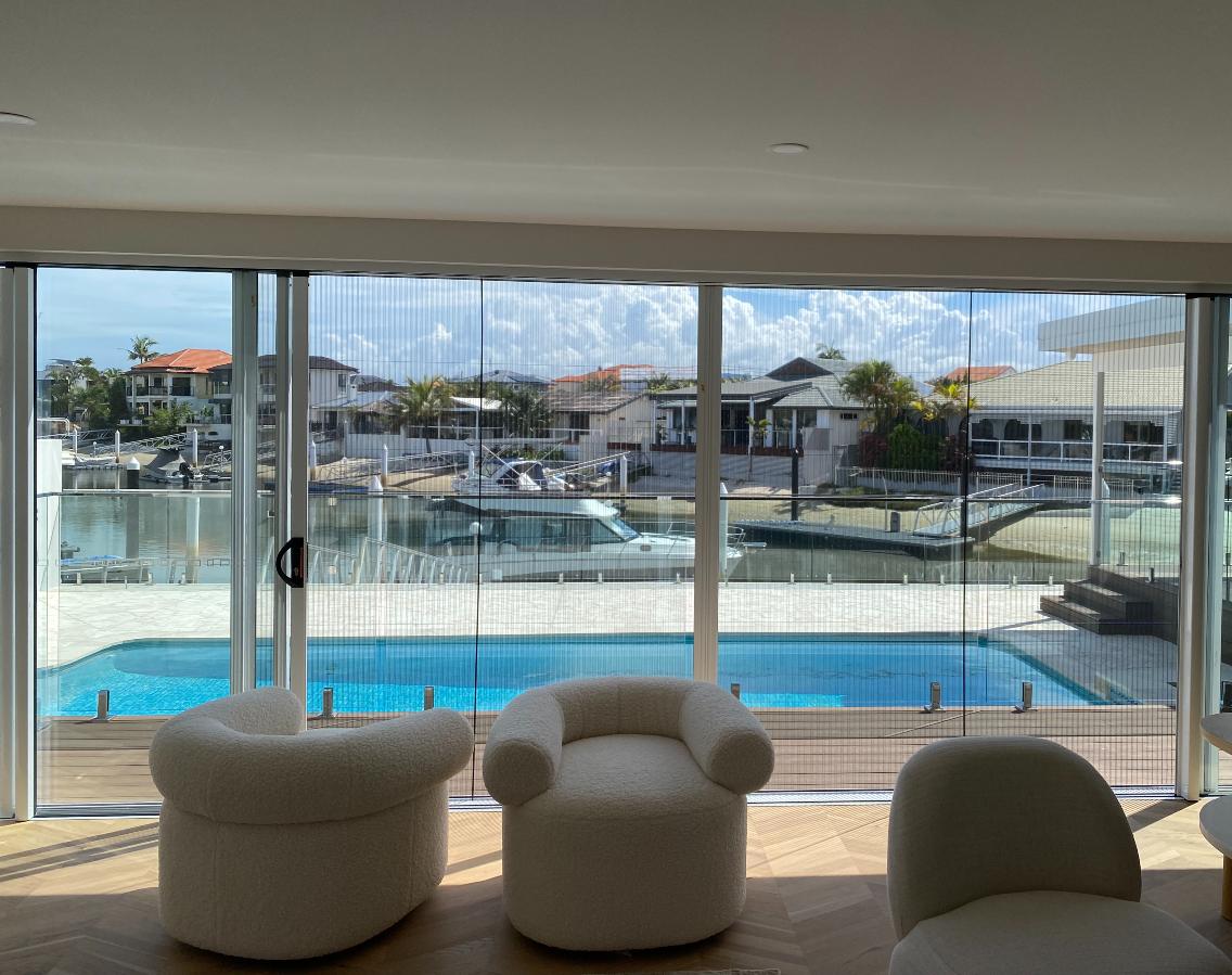 Double sliding retractable fly screens overlooking pool in Mermaid Waters