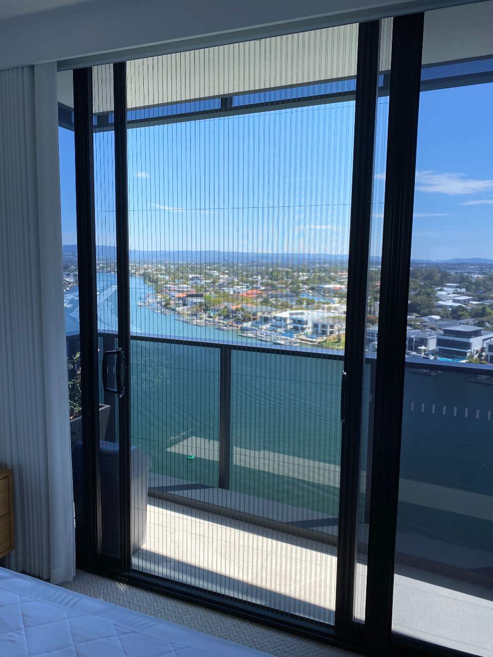 Sliding door retractable screen overlooking canal water view, Runaway Bay on the Gold Coast.