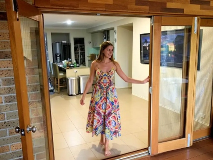 lady-walking-through-screened-french-doors-webp-web-430x322px lady walking through screened french doors
